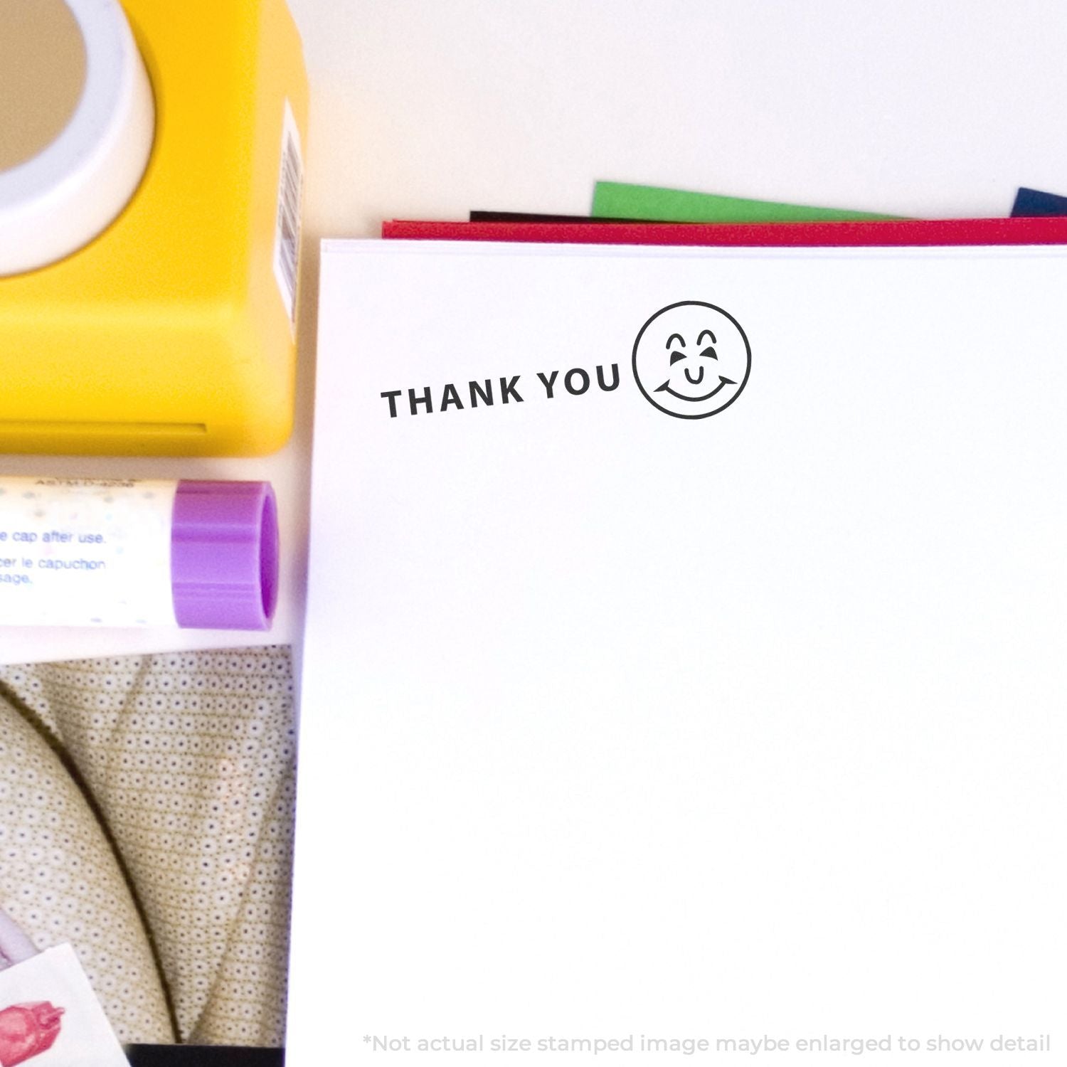 Thank you message on a white card with smile icon next to colorful skincare and hygiene items for customer appreciation.