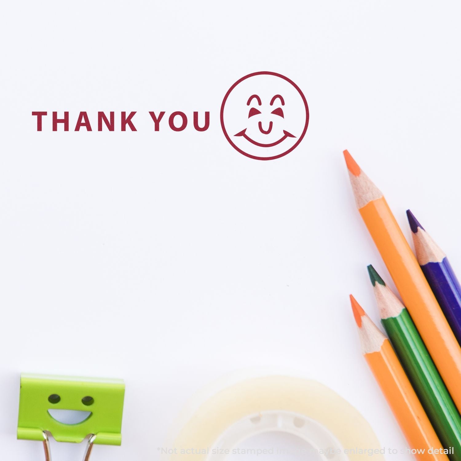 Thank you smiley stamp with colorful pencils on white paper, creative stationery background.