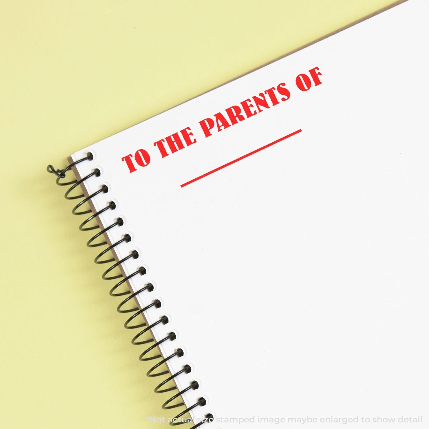 Spiral notebook cover with red text To the Parents Of on a yellow background, ideal for parenting and family communication.