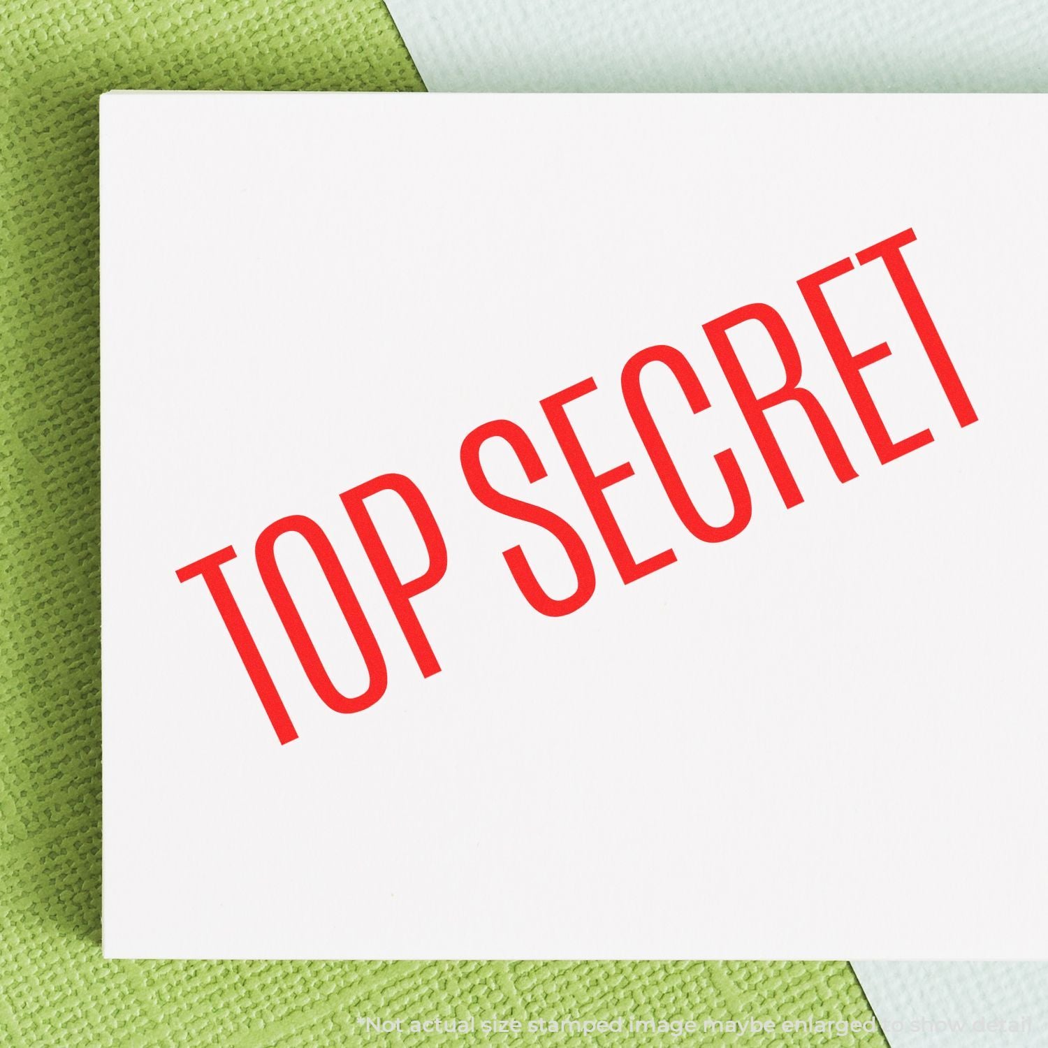 Top secret stamp on white paper card with green textured background, confidential document concept.