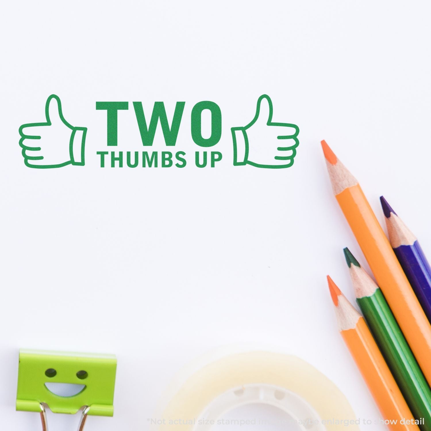 Two thumbs up text with green thumbs icons, colored pencils, and stationery on a white background.