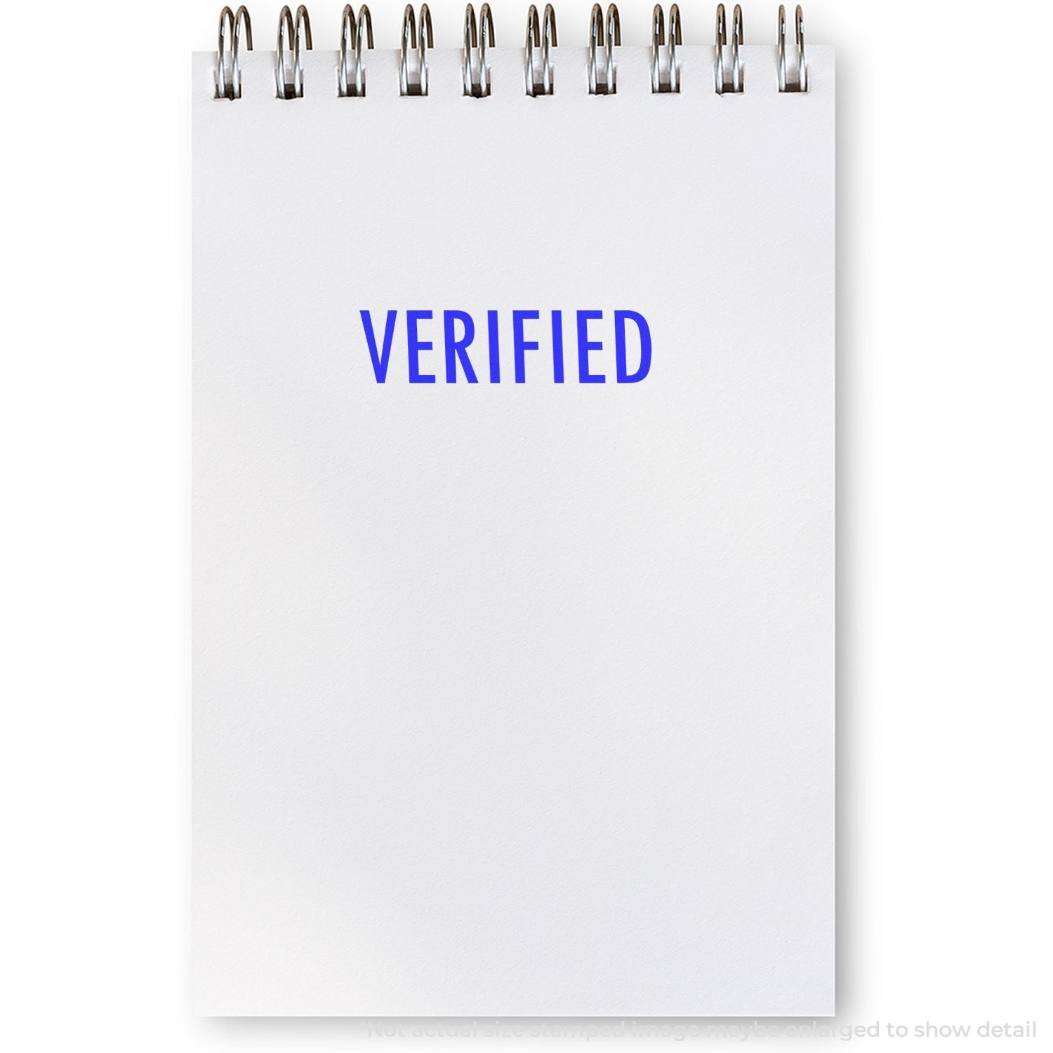 Verified stamp on blank spiral notebook page, concept of approval, validation, and authentication.