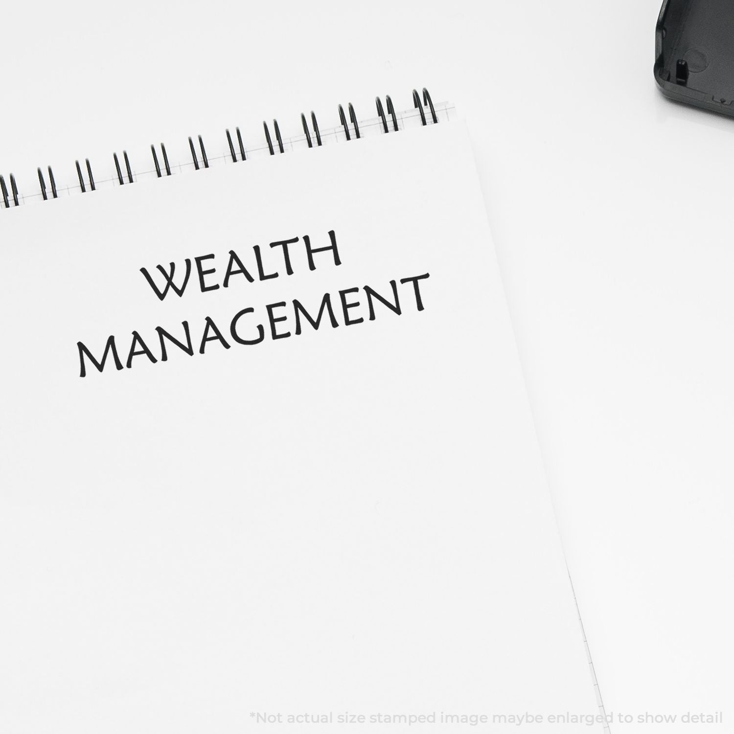 White notebook with Wealth Management text, concept of financial planning, investment advisory, and personal finance strategy.