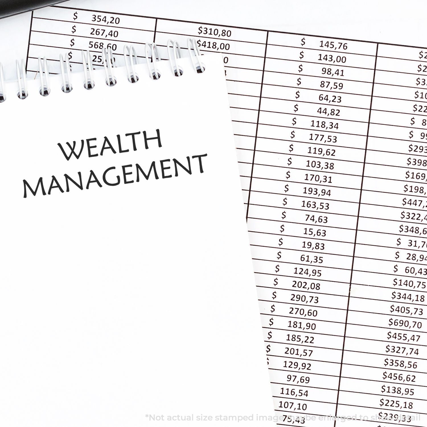 Wealth management notebook on financial spreadsheet with dollar amounts, representing investment planning and personal finance.