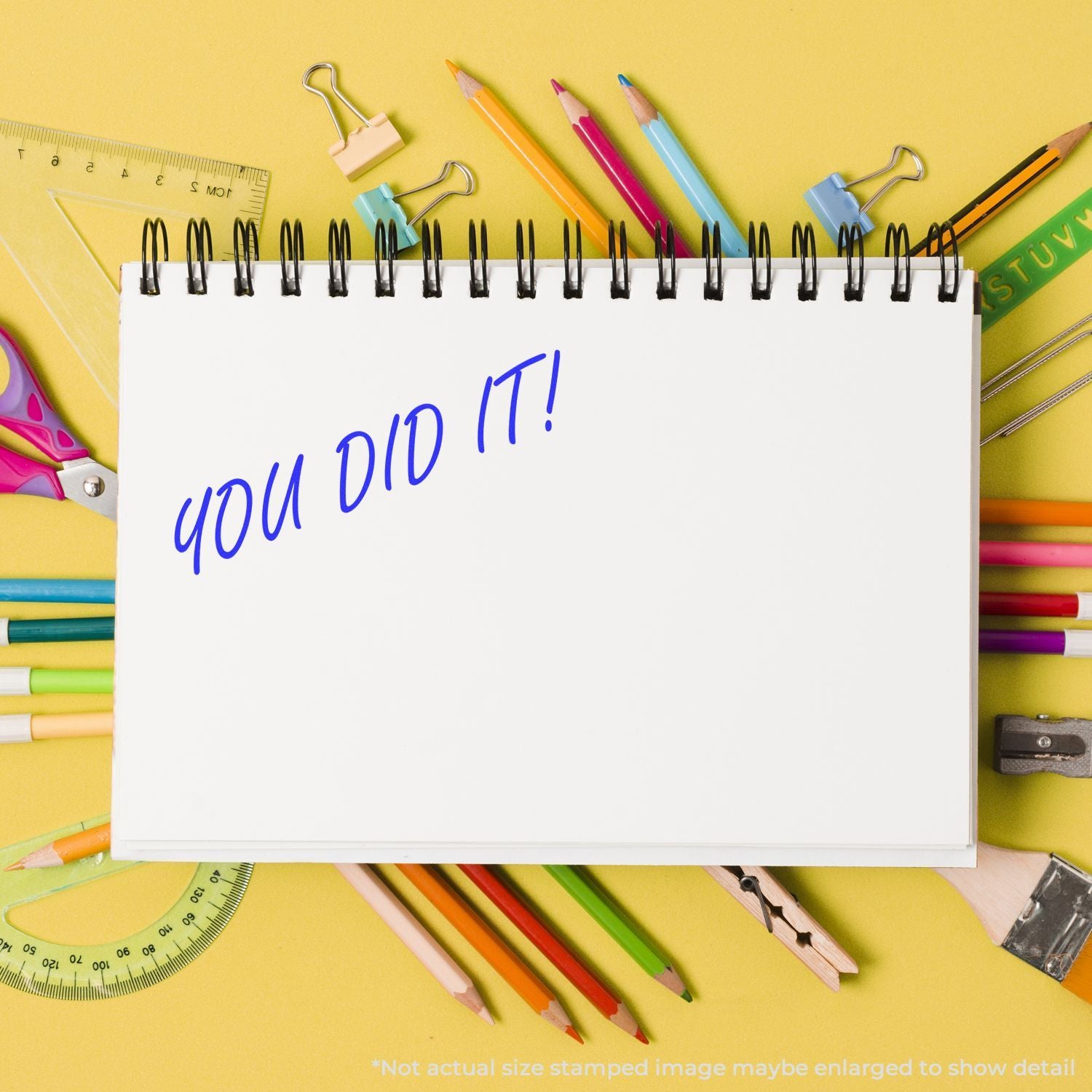 Colorful school supplies around a notebook with You did it! text on a yellow background, back to school success concept