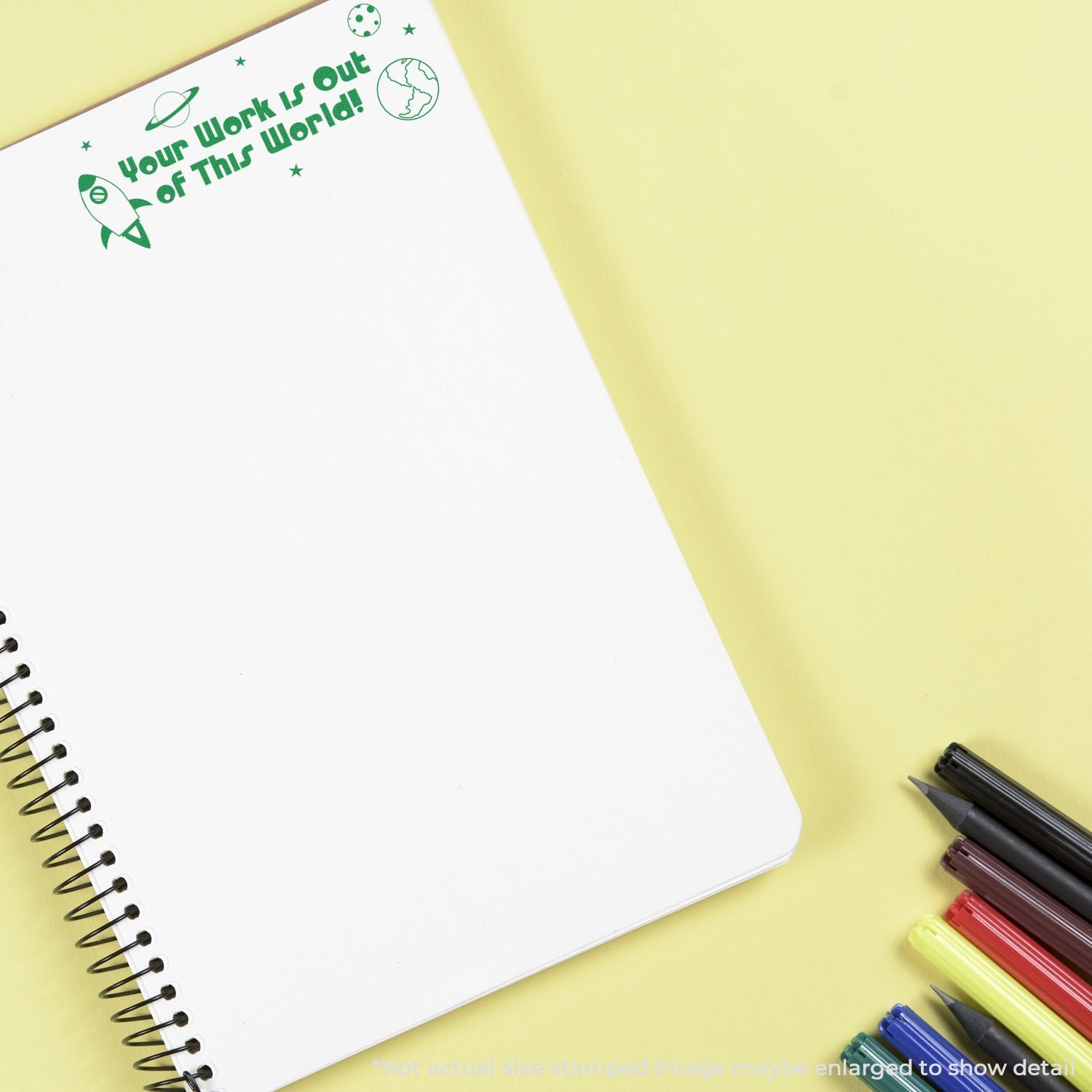 Motivational notebook page with green Work is out of this world rocket design for office productivity and team motivation