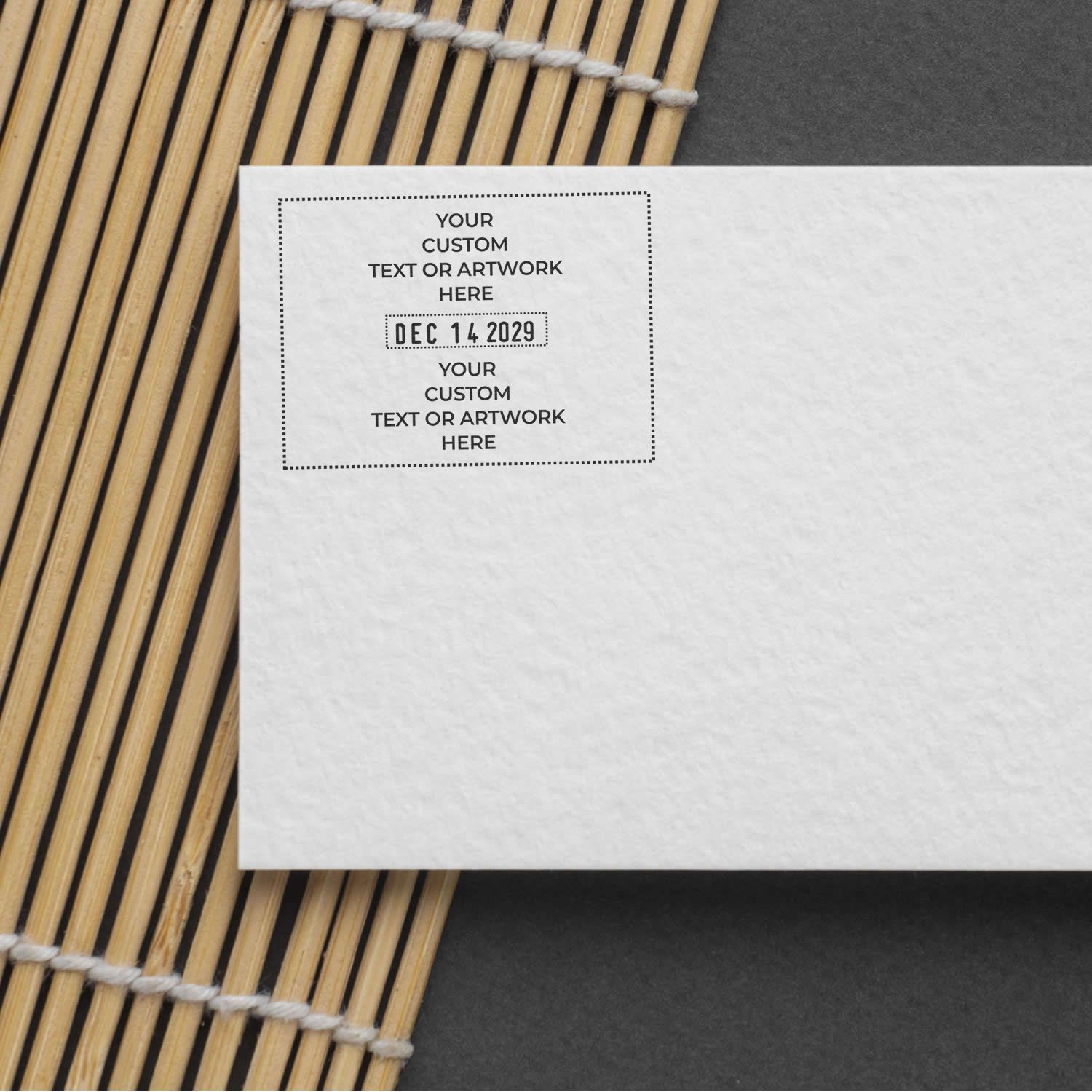 Blank white custom invitation card mockup with date placeholder, placed on a bamboo mat background.