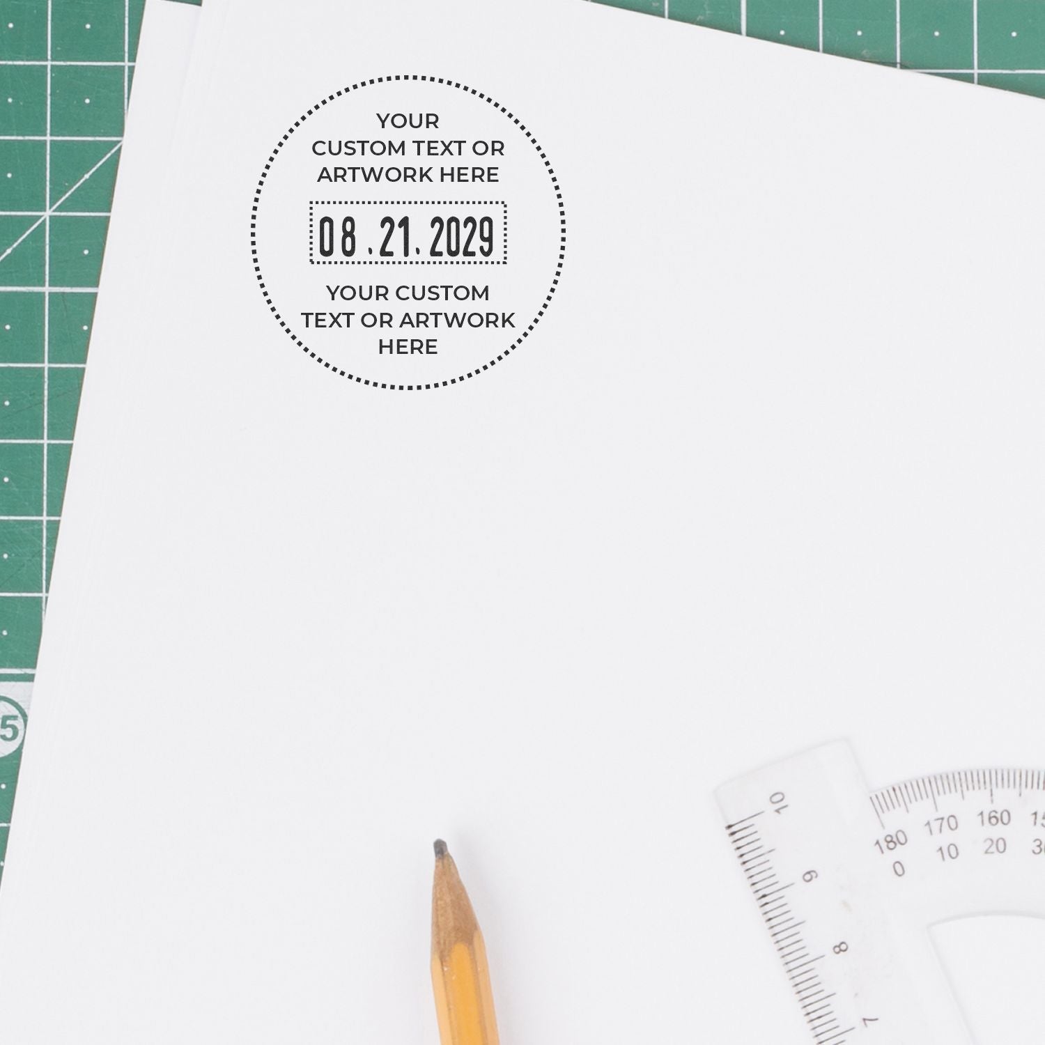 Customizable printable paper template with circular text placeholder, pencil, ruler, and cutting mat background