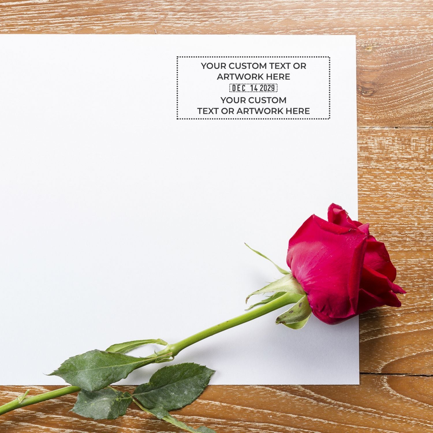 Blank personalized greeting card with red rose on wooden table, elegant floral invitation mockup.