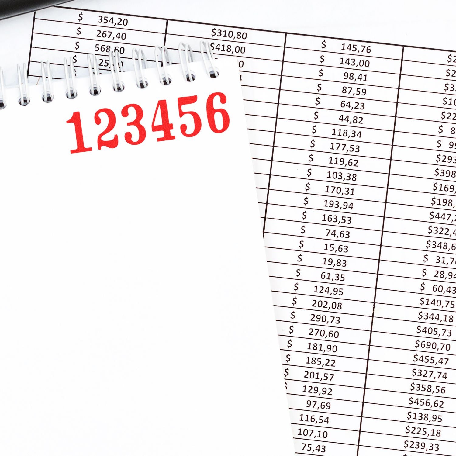 Spiral notebook with 123456 over financial spreadsheet data, accounting and budgeting concept