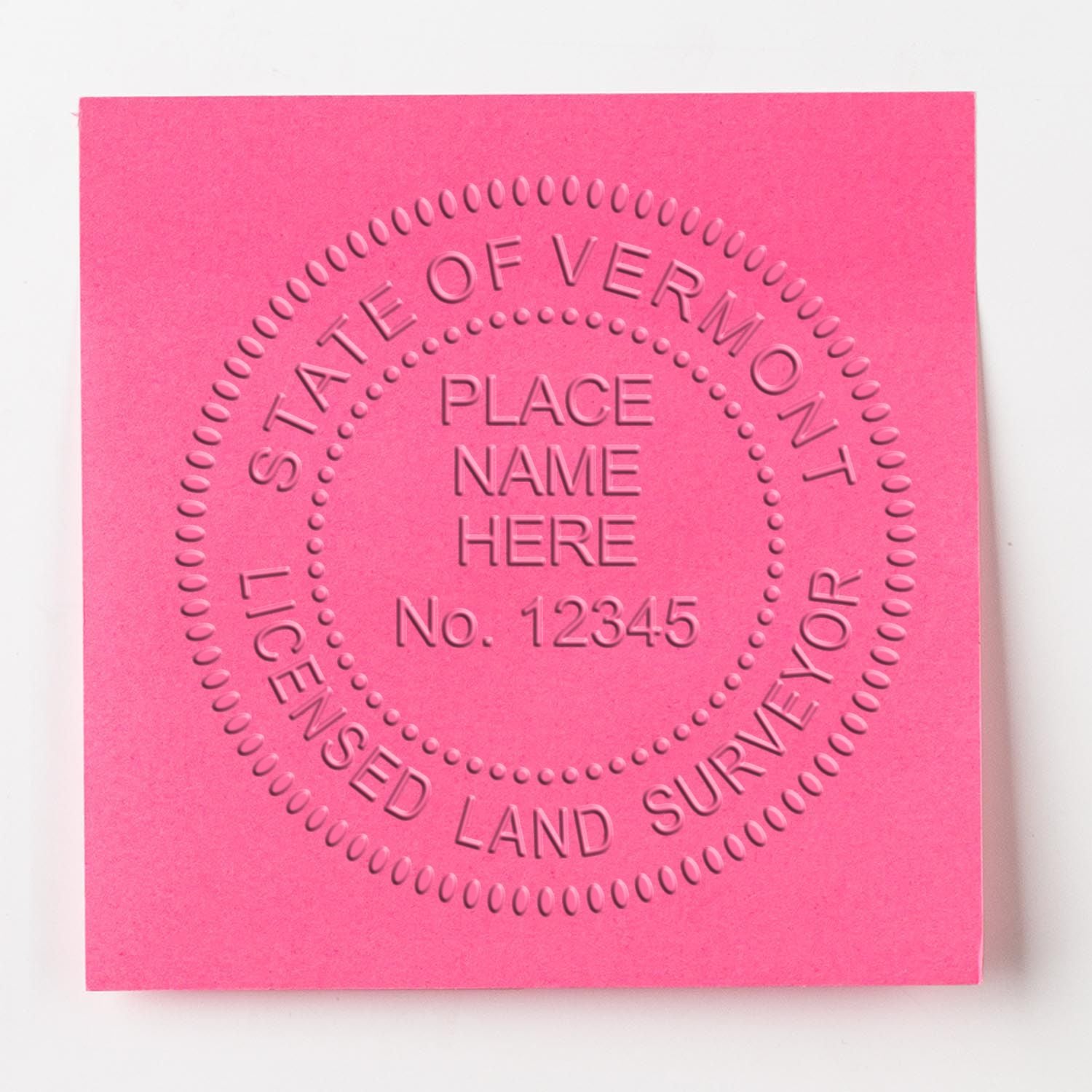 Pink embossed State of Vermont licensed land surveyor card with circular text and placeholder place name, No. 12345