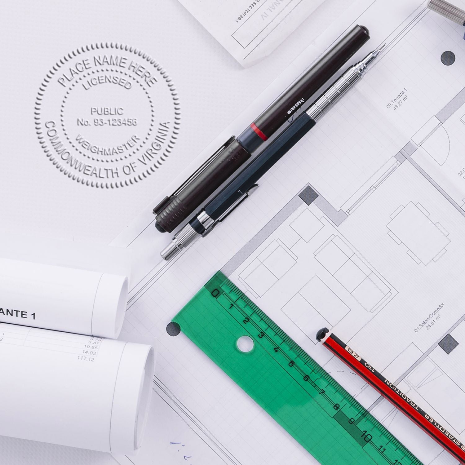 Architectural blueprint with drafting pens, ruler, and official seal on construction plans