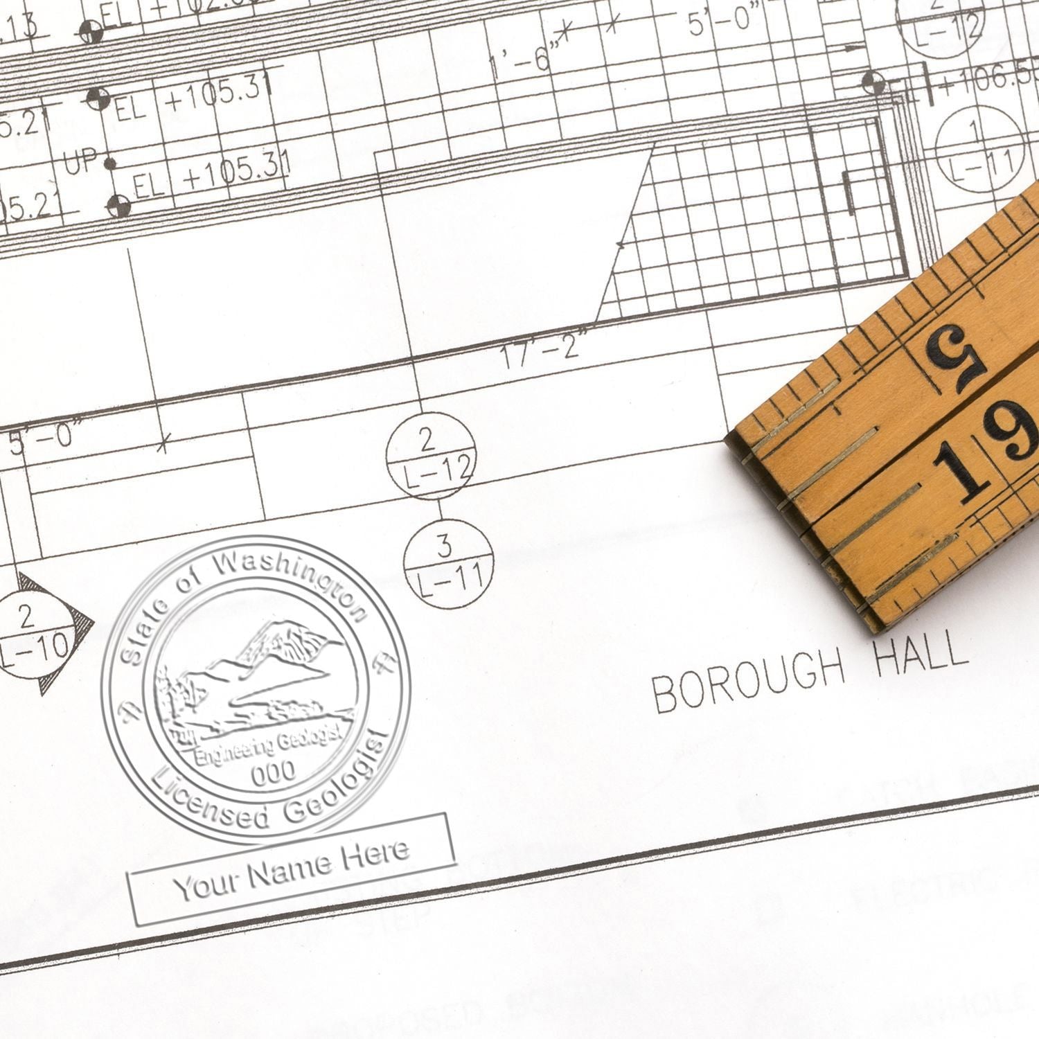 Architectural blueprint with measuring tape, engineering floor plan, and Washington state seal on a drafting drawing.