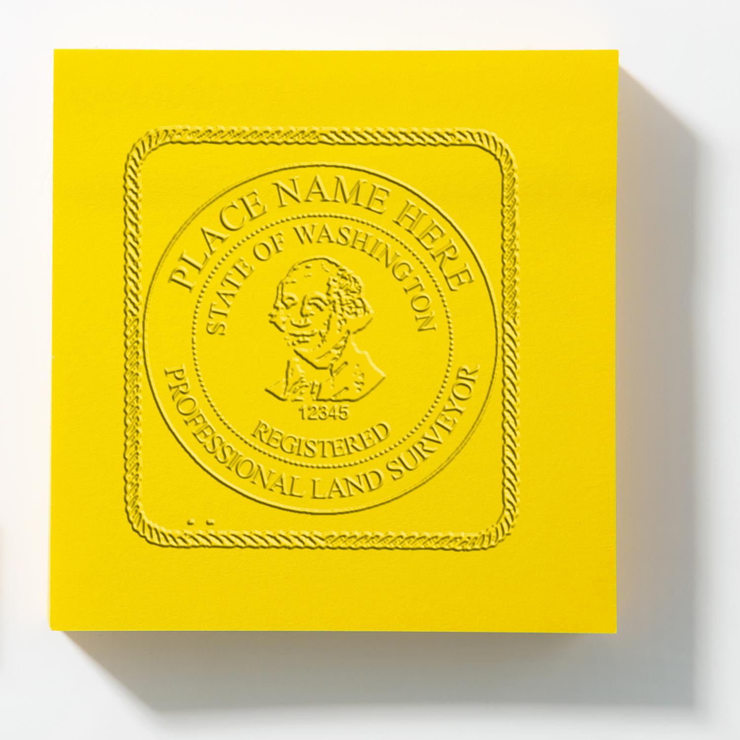 Yellow embossed State of Washington Professional Land Surveyor seal plaque with raised circular emblem.