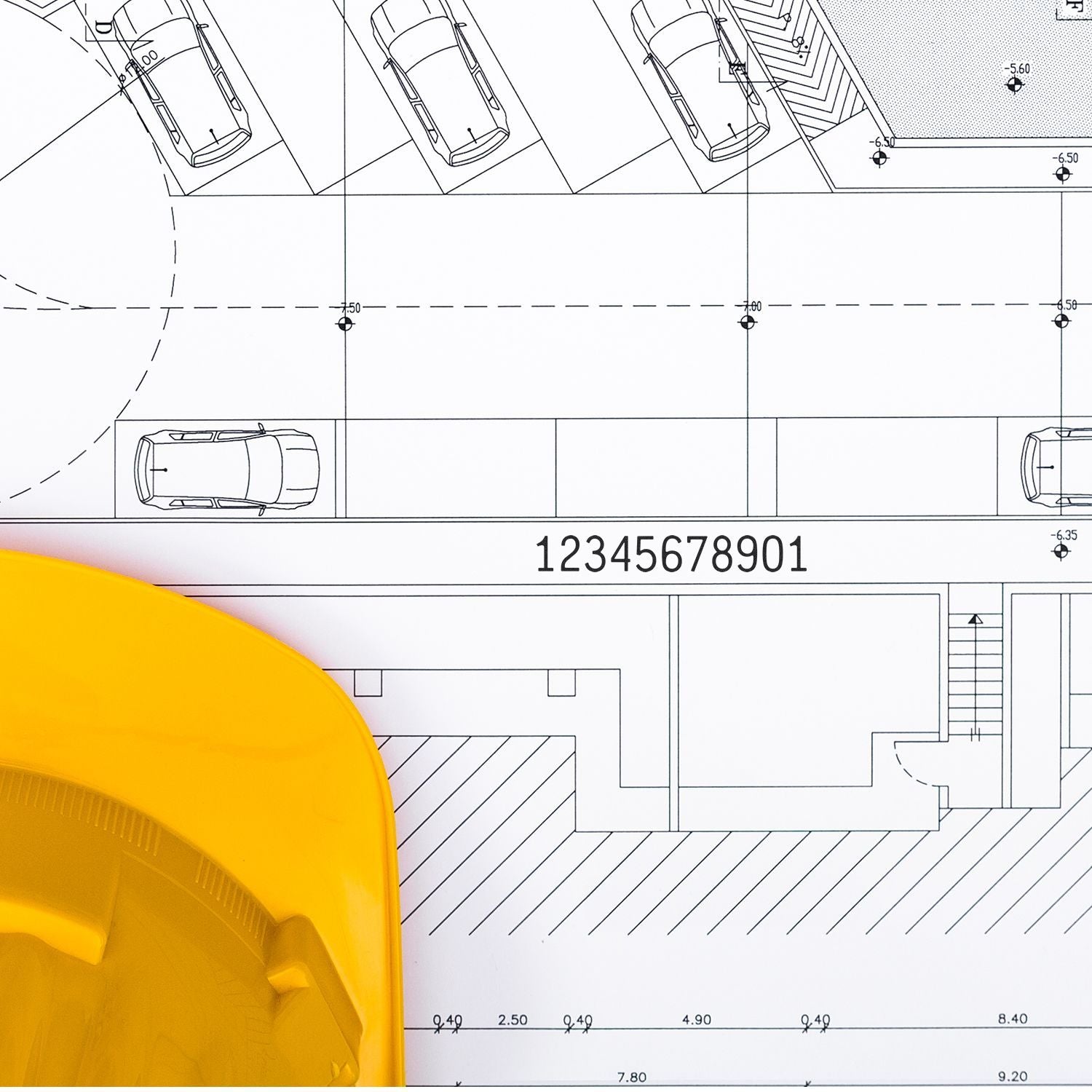Architectural site plan blueprint with parked cars and yellow construction hard hat on building design drawing