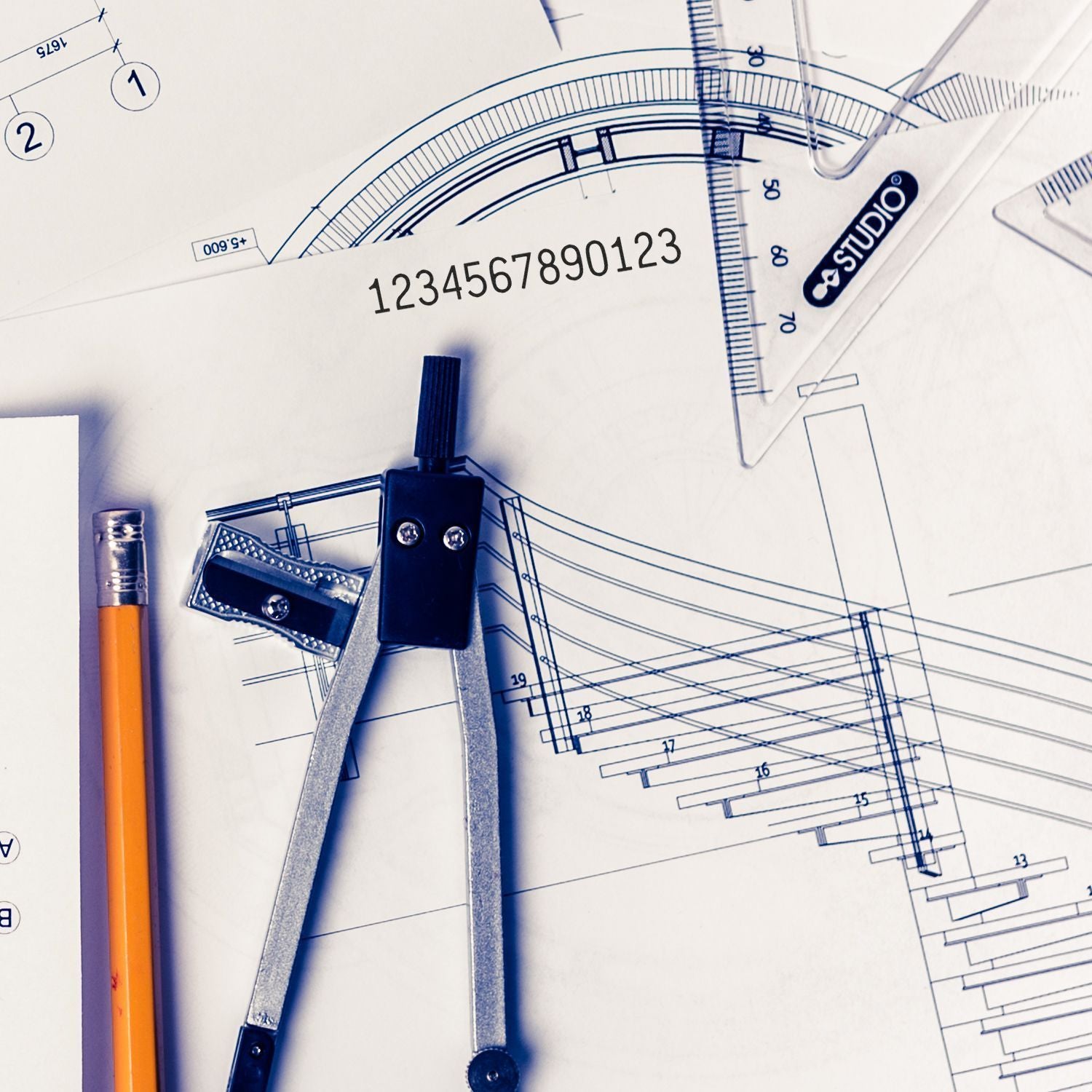 Architectural blueprint with drafting compass, ruler, pencil, and design tools for technical drawing and engineering plans