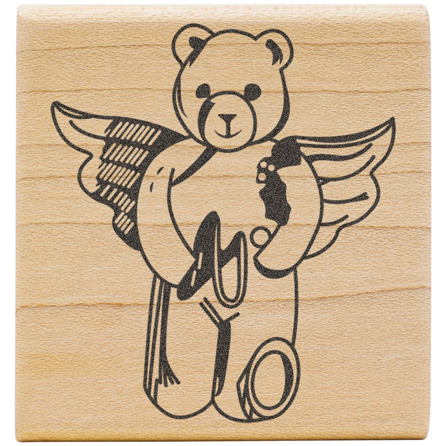 Wooden stamp with winged teddy bear design, black engraved bear illustration on natural wood block.