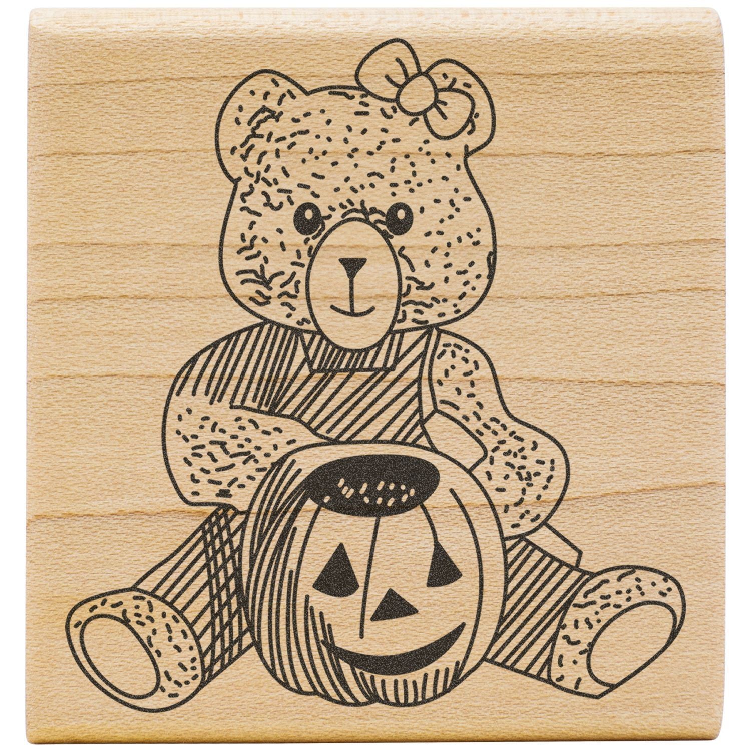 Halloween teddy bear sitting on a jack-o-lantern pumpkin, engraved line art on wooden background.