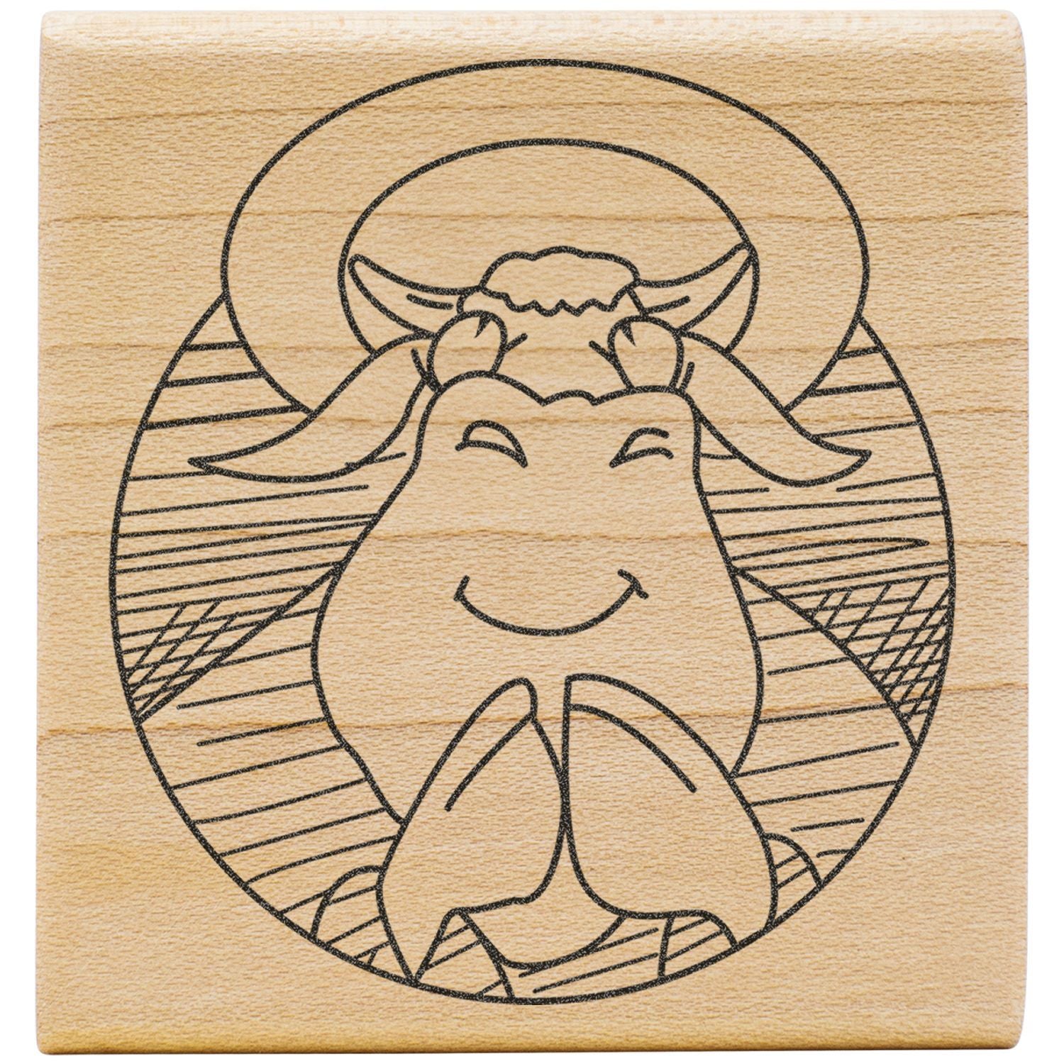 Cute smiling cow illustration on a wooden stamp block with engraved farm animal design