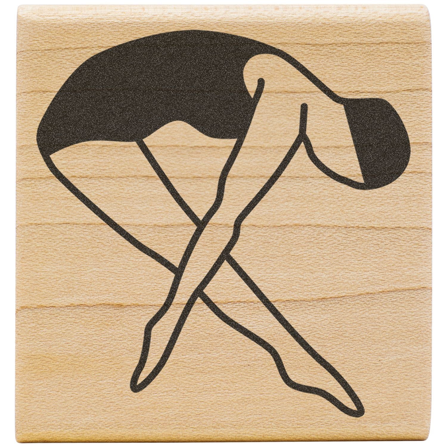 Wooden stamp with black yoga pose icon on a natural wood background.