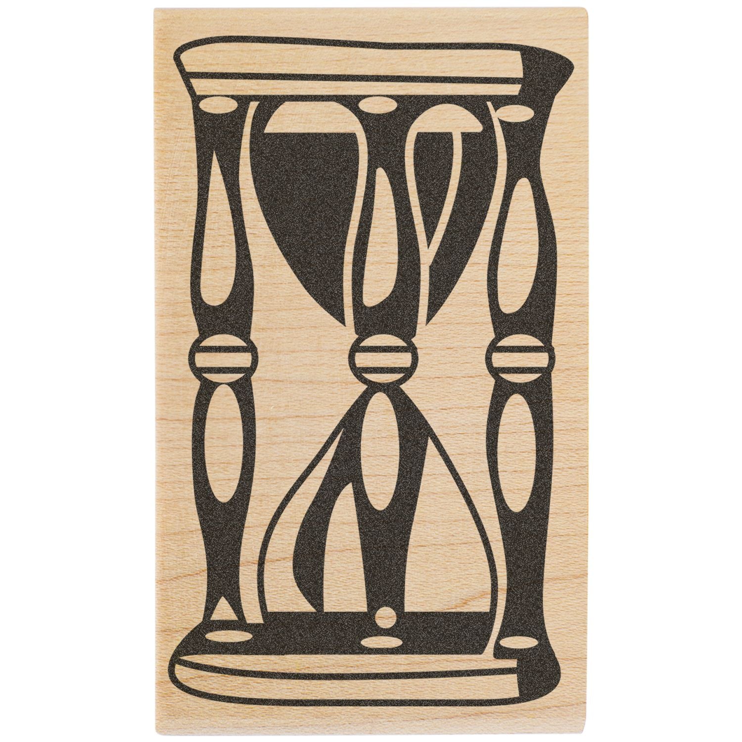 Abstract black geometric tribal design on a light wooden block stamp.