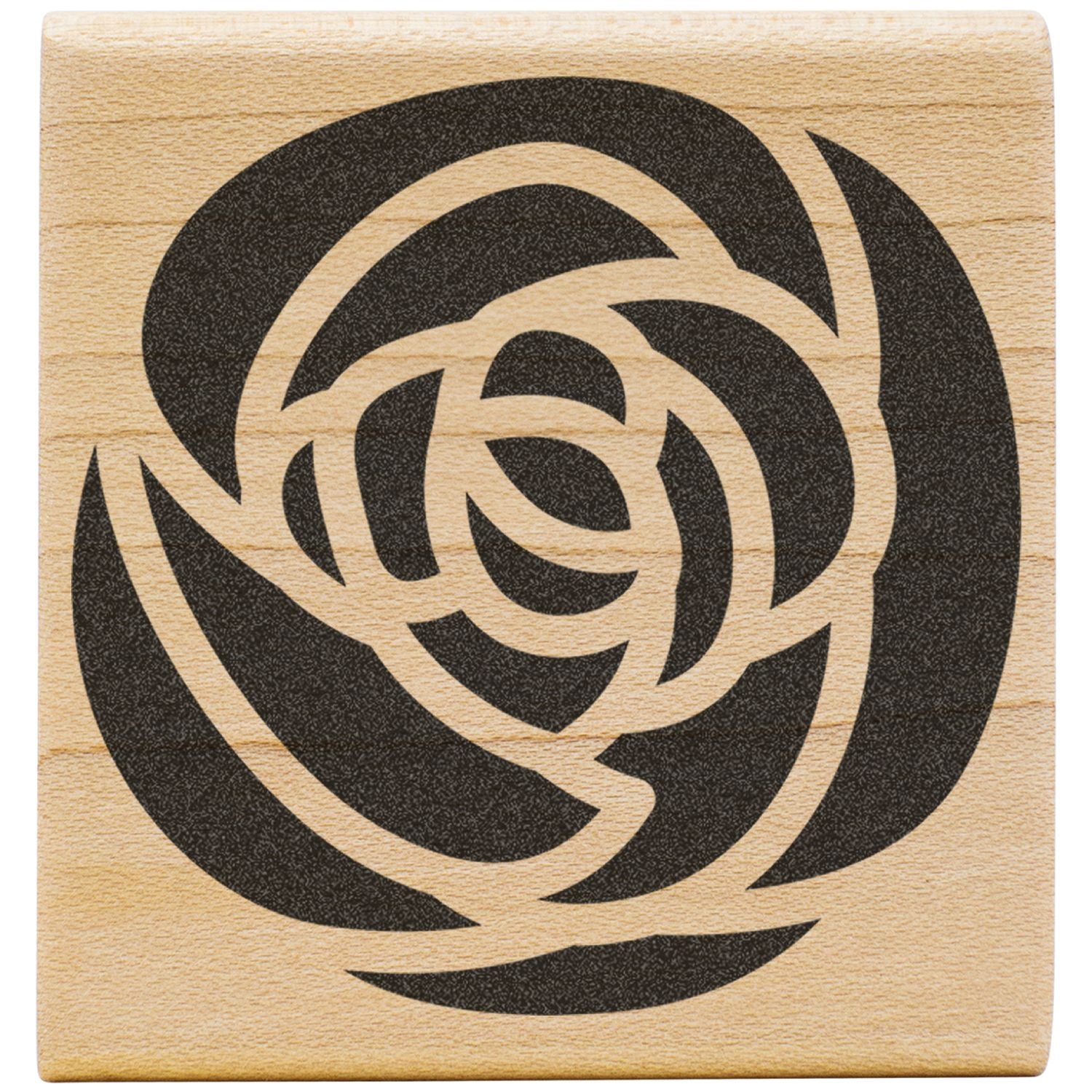 Abstract black rose design engraved on a light wood block.