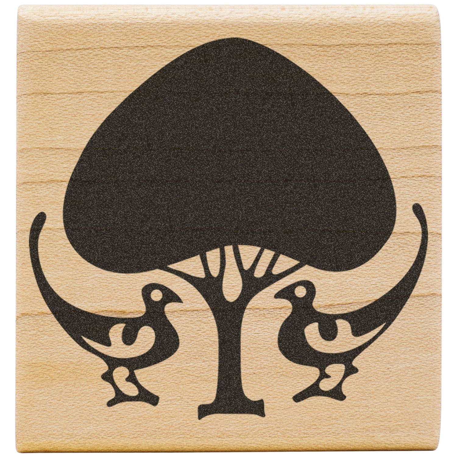 Black stylized tree and two birds graphic on a wooden background