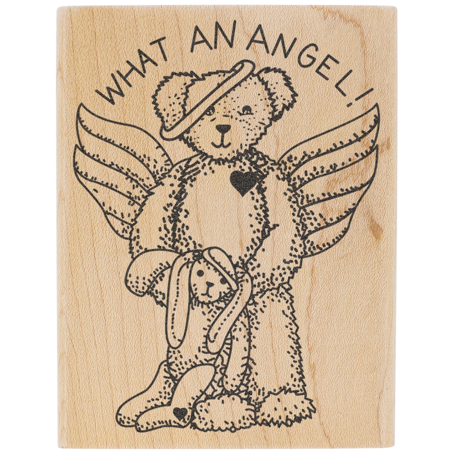 Cute wooden stamp of a teddy bear angel with wings and What an Angel! text on a light wood background.