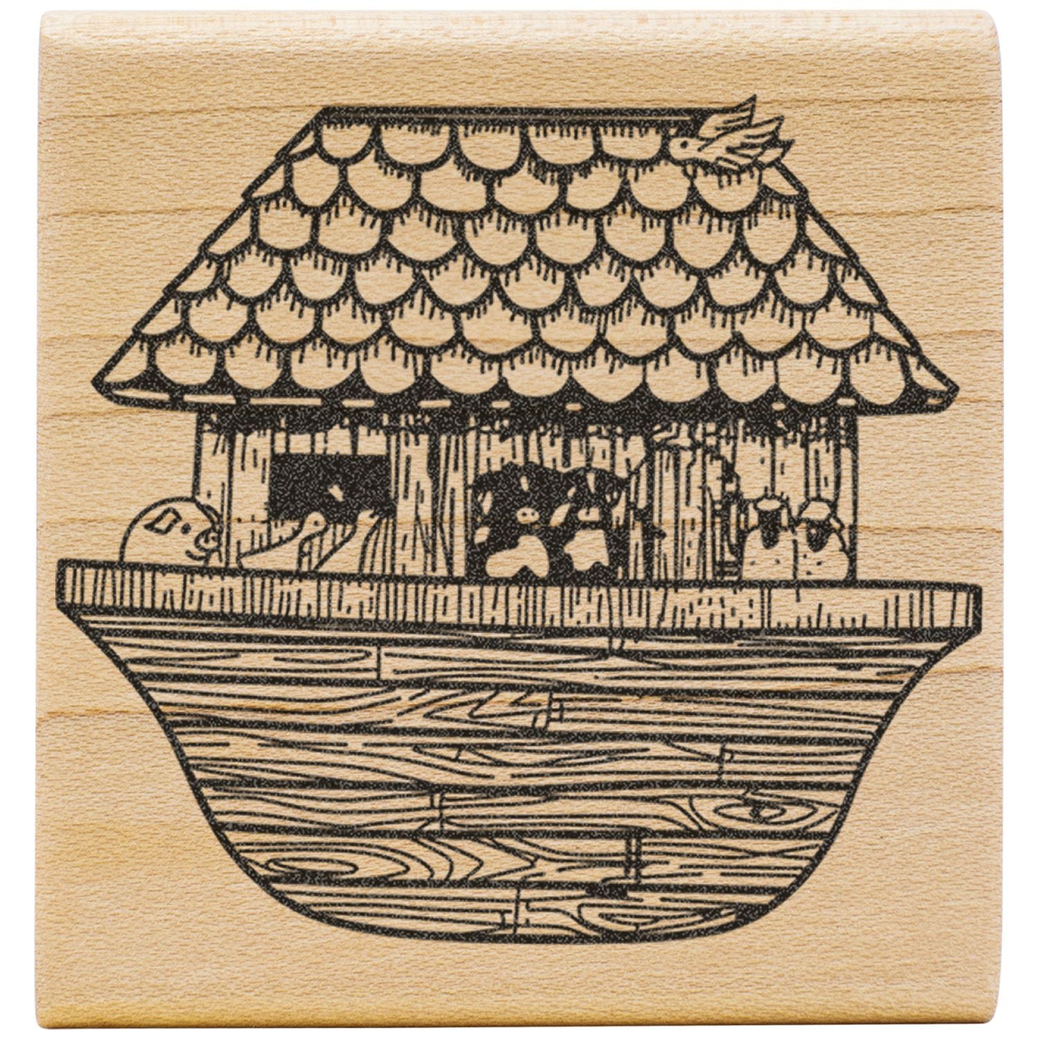Whimsical hand-drawn house illustration engraved on a wooden surface with shingled roof and woodgrain base.