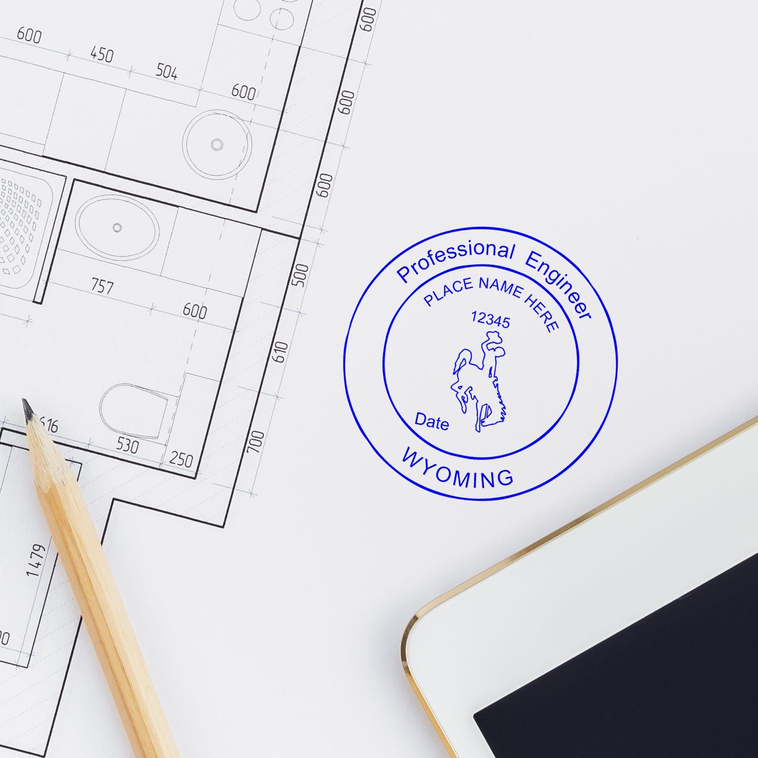 Architectural floor plan with pencil, tablet, and Wyoming professional engineer stamp logo