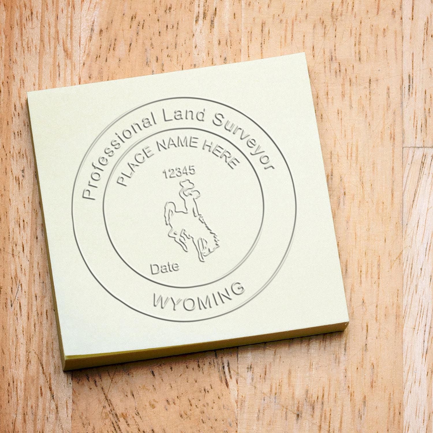 Custom professional land surveyor stamp with Wyoming state logo and engraved placeholder text on square plaque.
