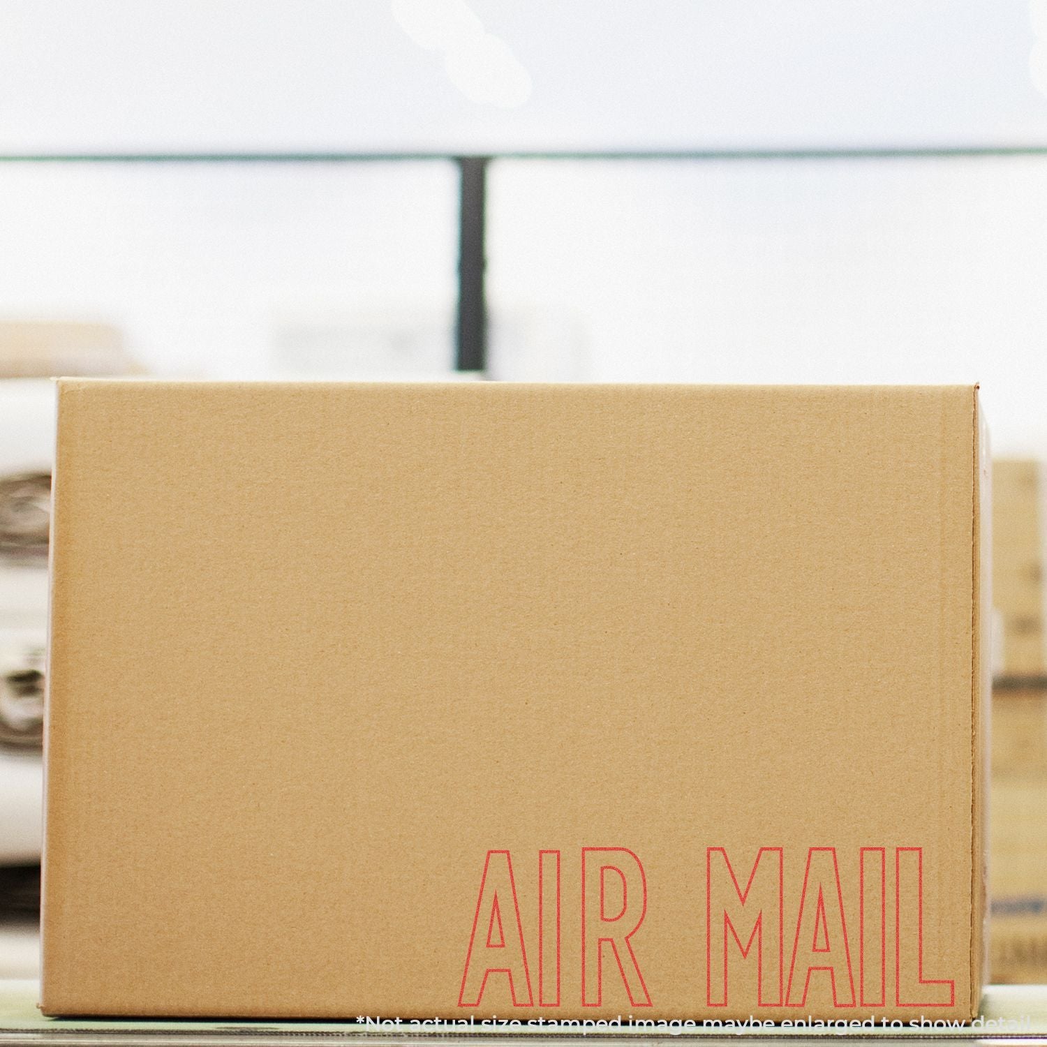 Close-up of an AIR MAIL shipping box, showing international air mail package delivery branding on cardboard.
