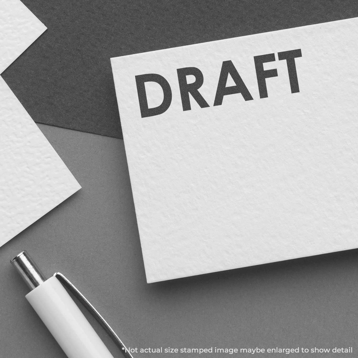 Draft document card reading DRAFT with pen on desk, illustrating writing, editing, and review before final print.