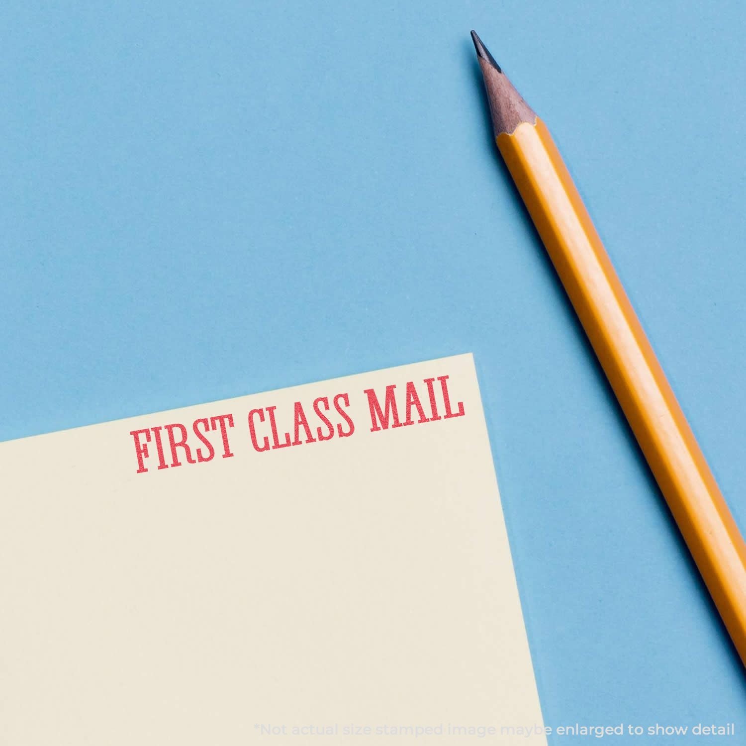 Yellow pencil beside First Class Mail envelope on blue background, symbolizing USPS first-class letter delivery and fast mail service.