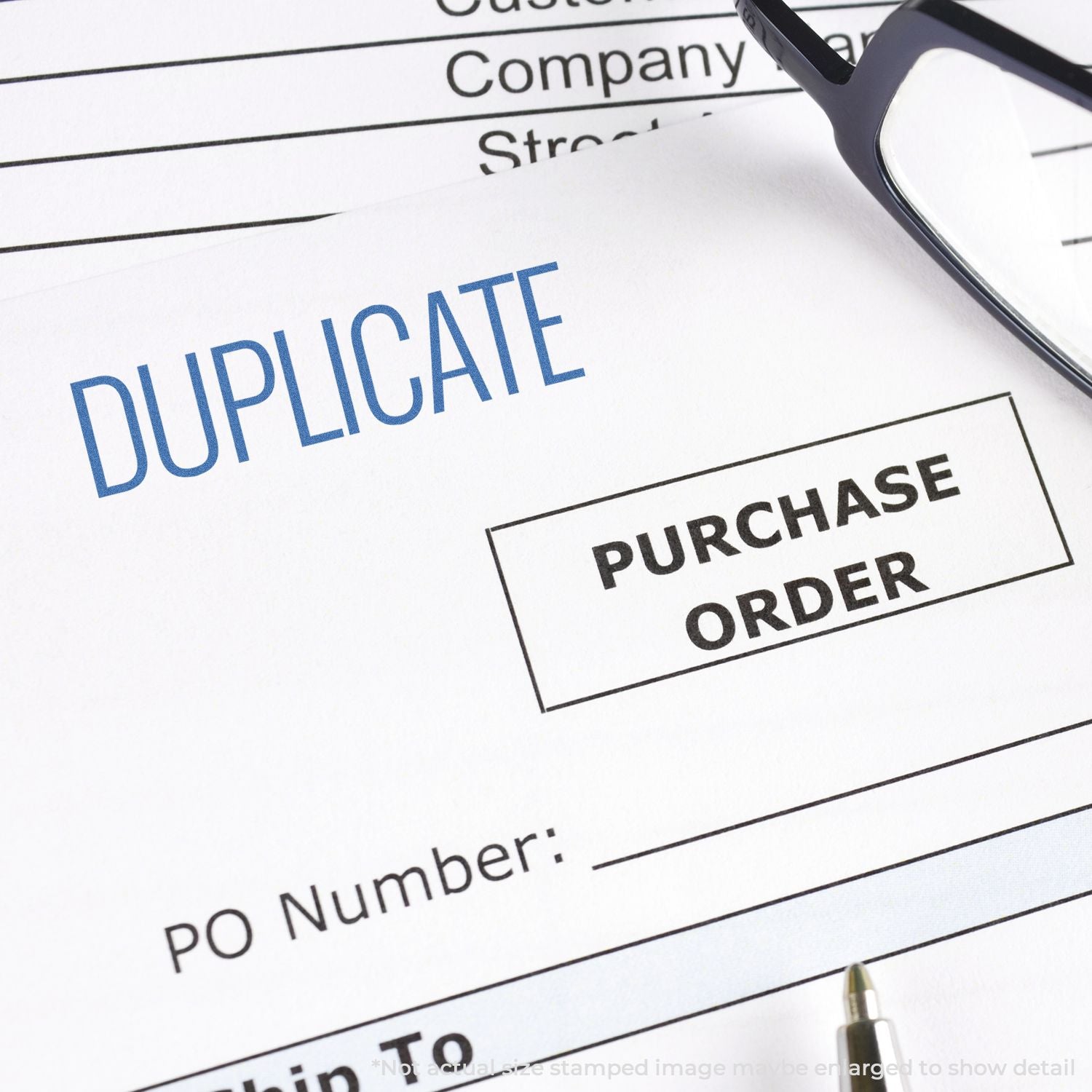 Duplicate purchase order document with Duplicate stamp and eyeglasses, for business procurement tracking and record keeping.