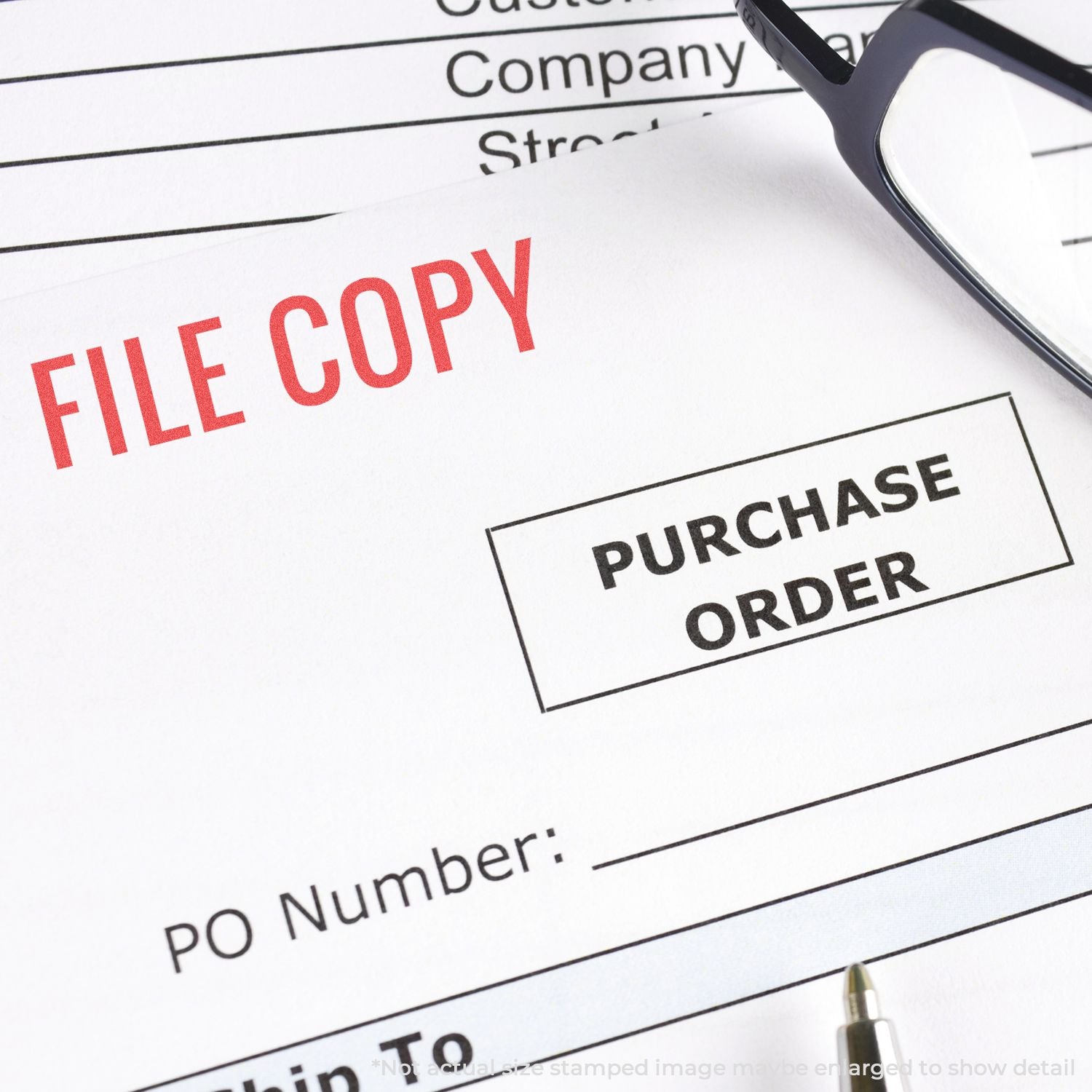 File copy stamp on purchase order document with glasses, highlighting purchase order processing and documentation for procurement.