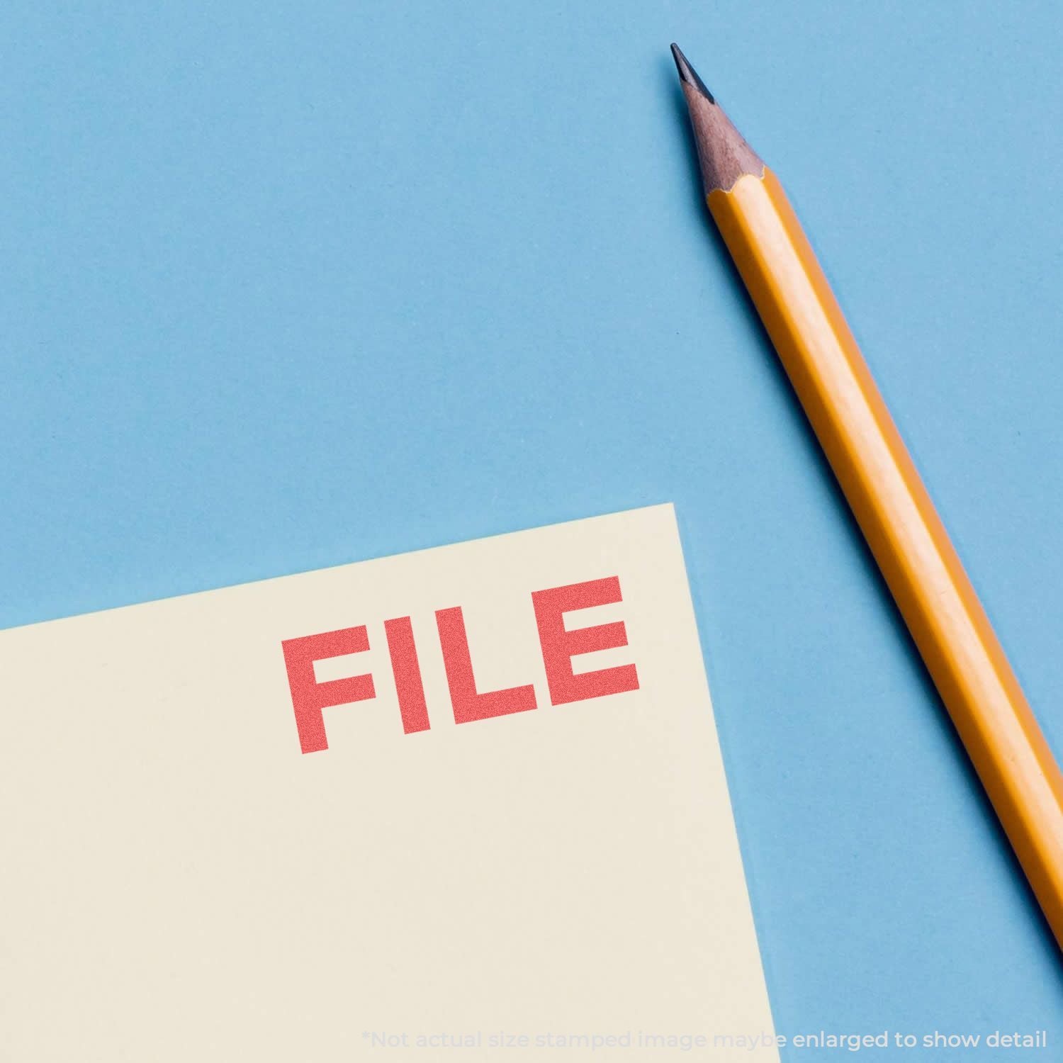 Close-up of a file folder labeled FILE with a yellow pencil on a blue background.