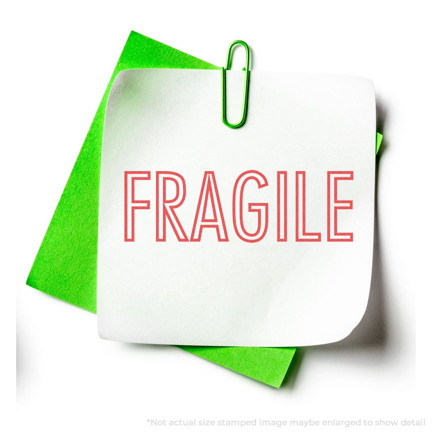 FRAGILE shipping label on white package with green folded paper background, warning handlers to handle with care.