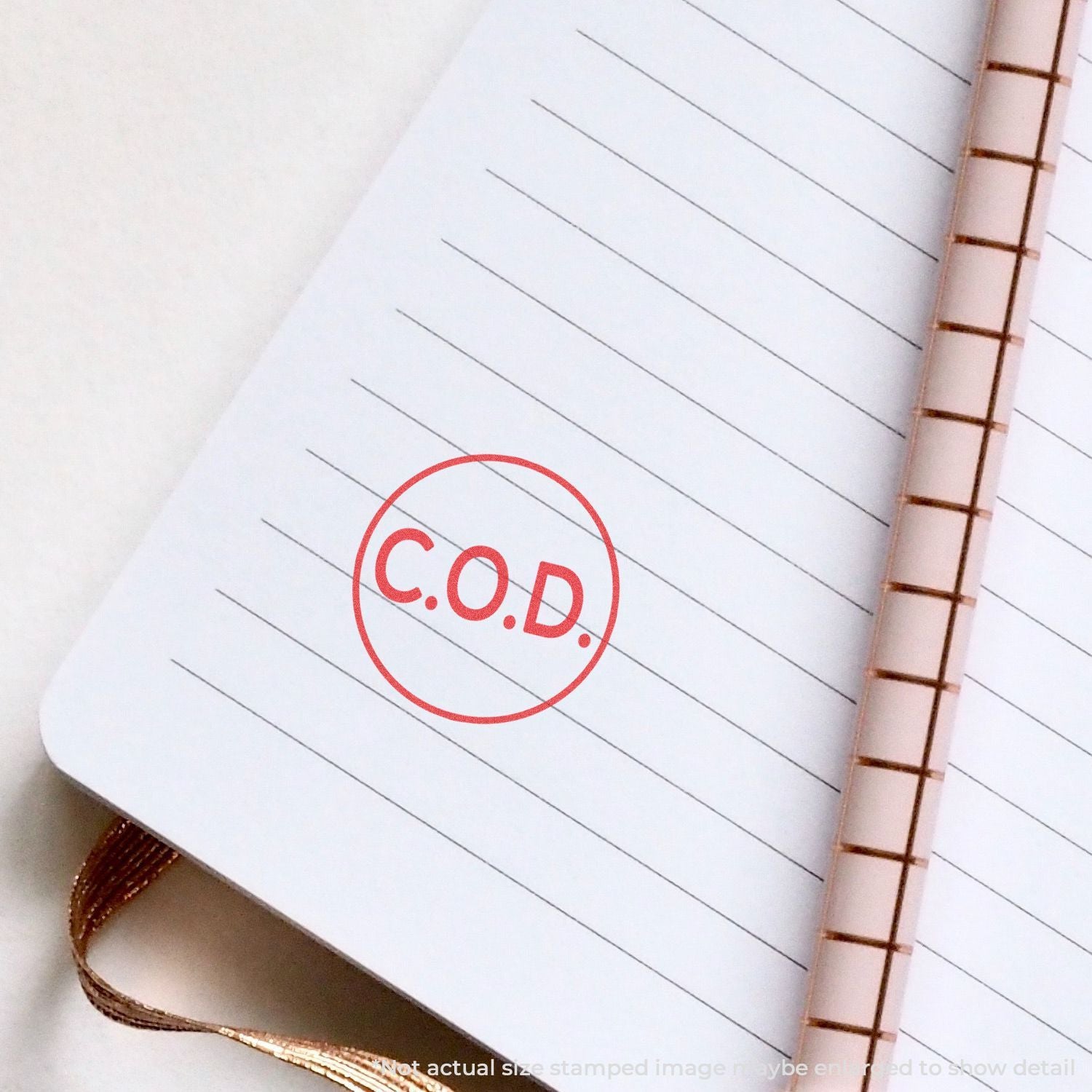 Cash on delivery C.O.D. stamp circled on lined notebook, highlighting COD shipping payment method.