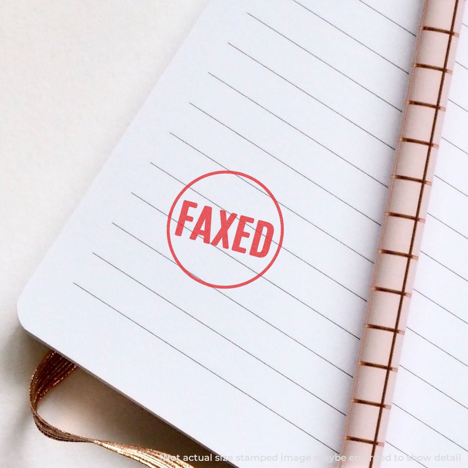 Close-up of faxed document stamp on lined notebook page, showing processed fax status and document transmission confirmation.