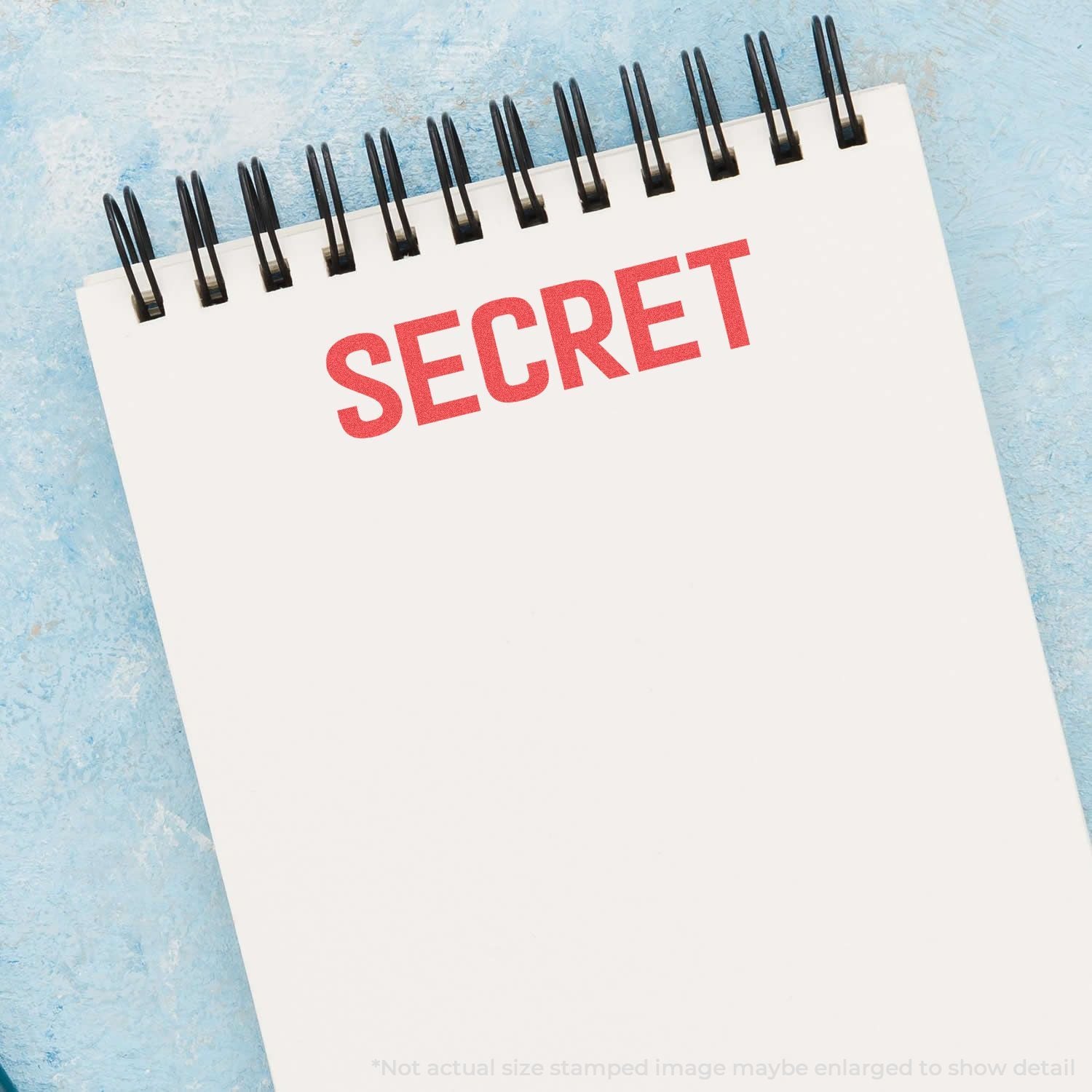 Spiral notebook with red SECRET text on a blue background, concept for confidential information.
