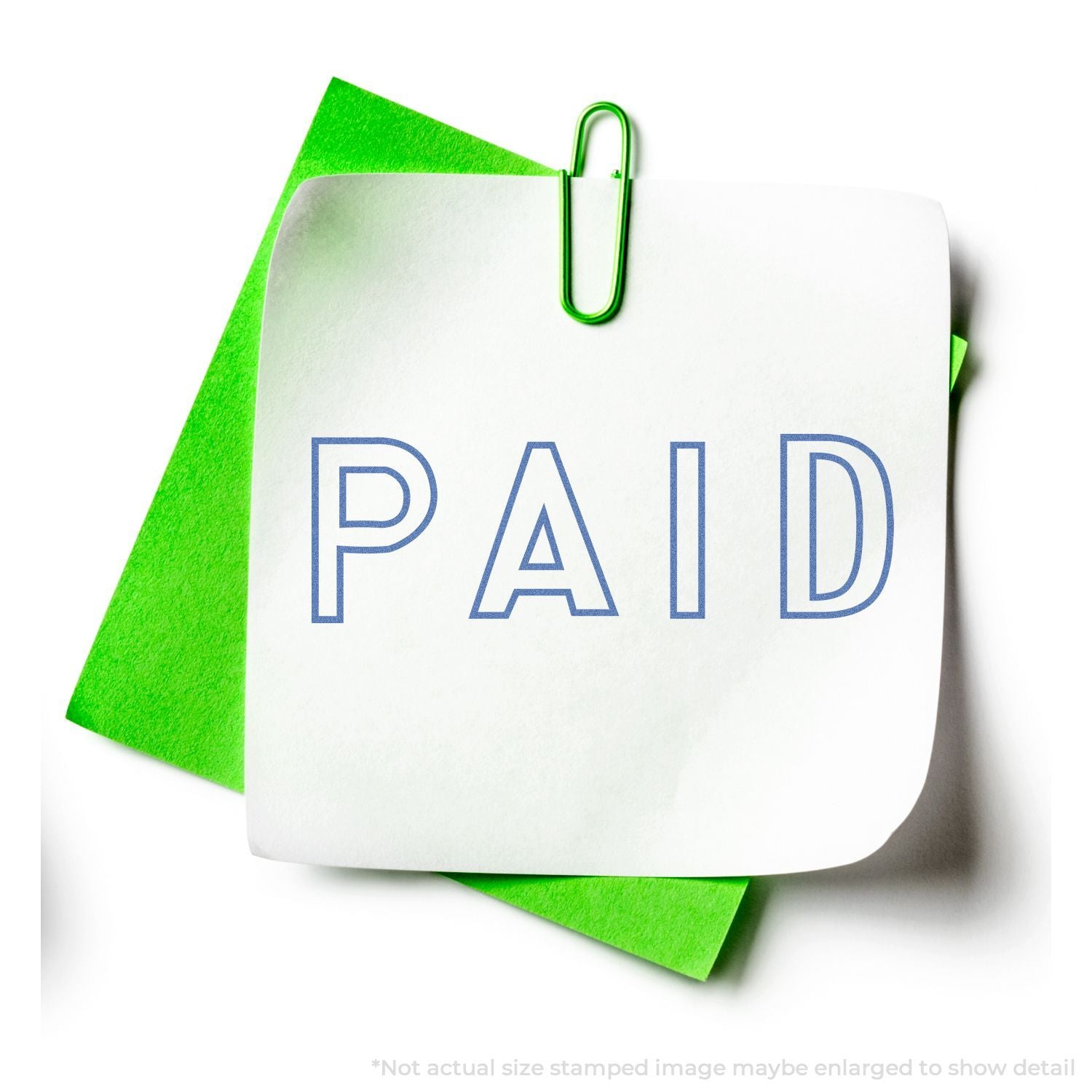 White sticky note with PAID stamp clipped to a green paper background, representing invoice payment and billing confirmation.